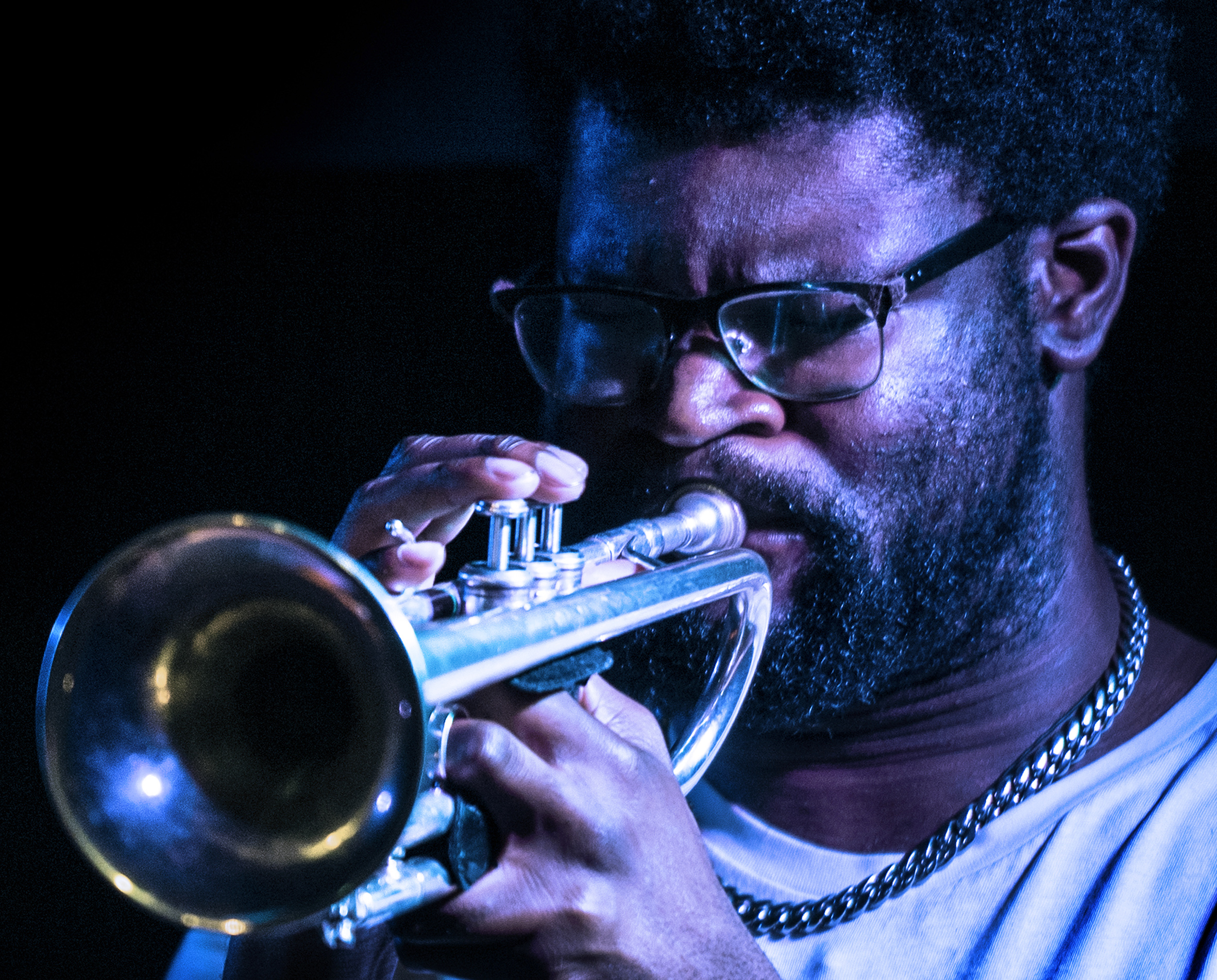 Close up photo of Joseph Oti playing the trumpet