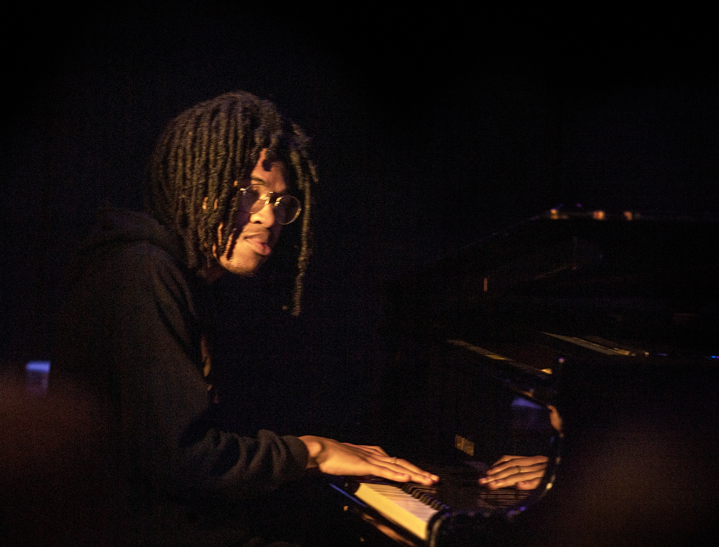 Colour photo of Luke Bacchus playing a grand piano
