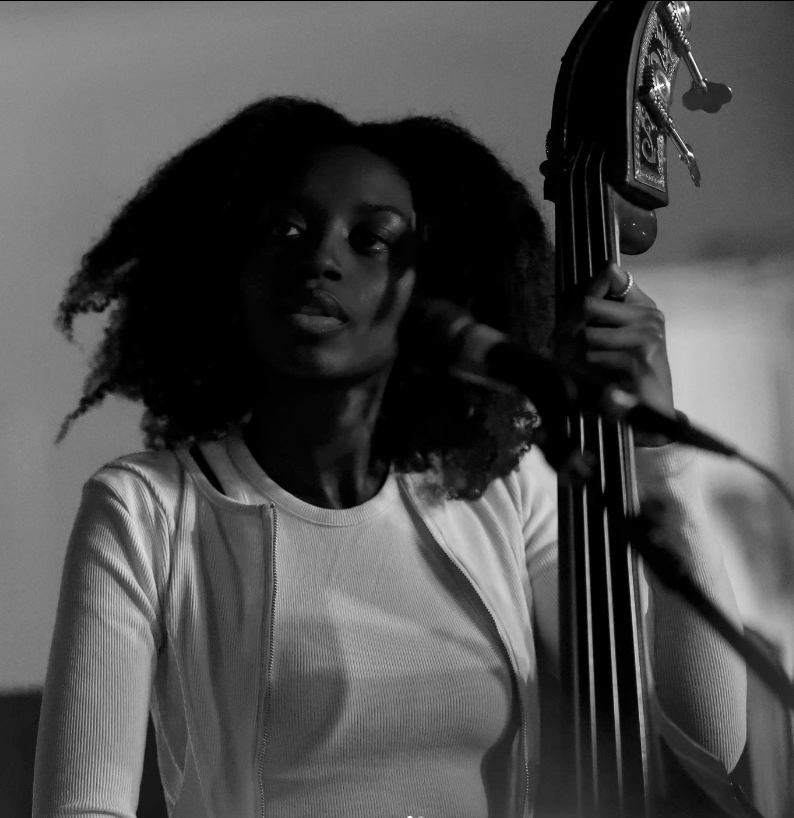 Amy Gadiaga posing with double bass and microphone - taken by John Prince
