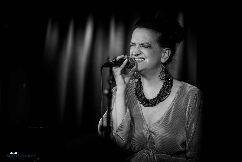 Esther Bennett with mic, singing, black and white photo - taken by Monika S Jakubowska